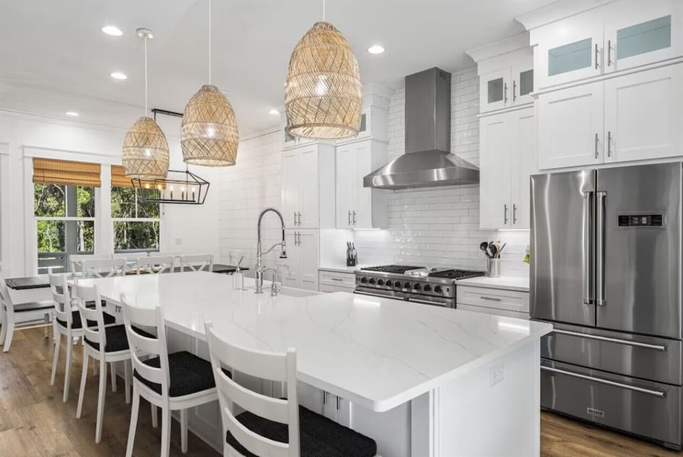 Your stunning white kitchen awaits, featuring professional appliances and a spacious island perfect for cooking memorable meals together.
