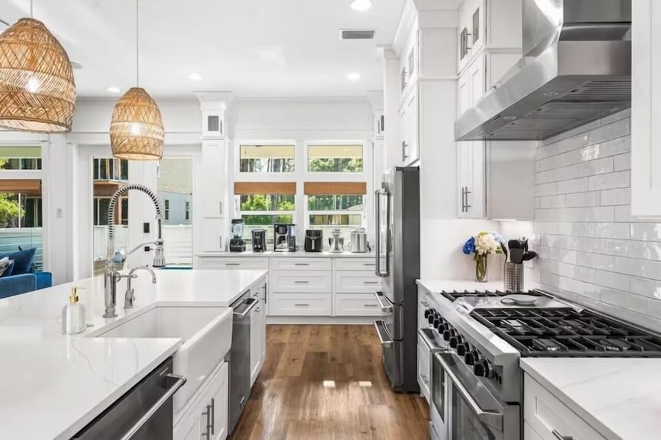 Step into your dream kitchen with pristine white cabinetry, gleaming marble countertops, and professional-grade appliances ready for your culinary adventures.