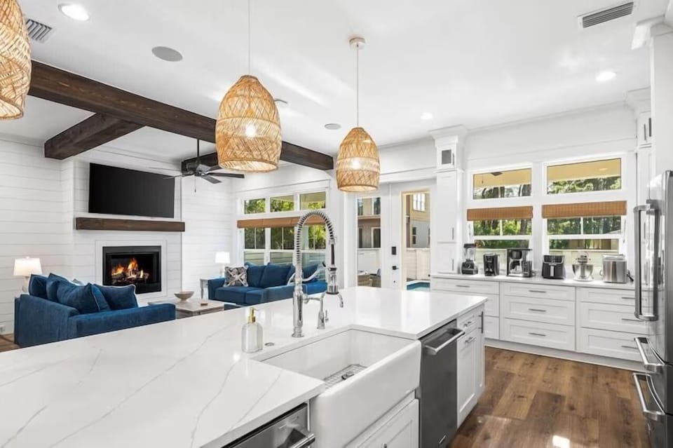 You'll love this bright open-concept space where your kitchen flows seamlessly into the cozy living area with fireplace.
