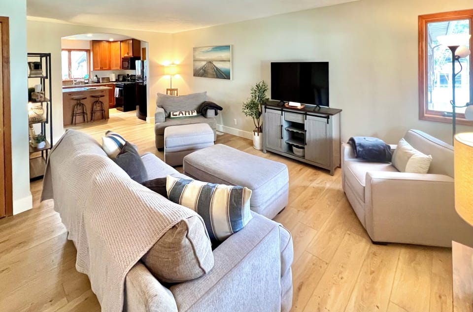 spacious living room with smart TV, comfortable couch for extra sleeping space