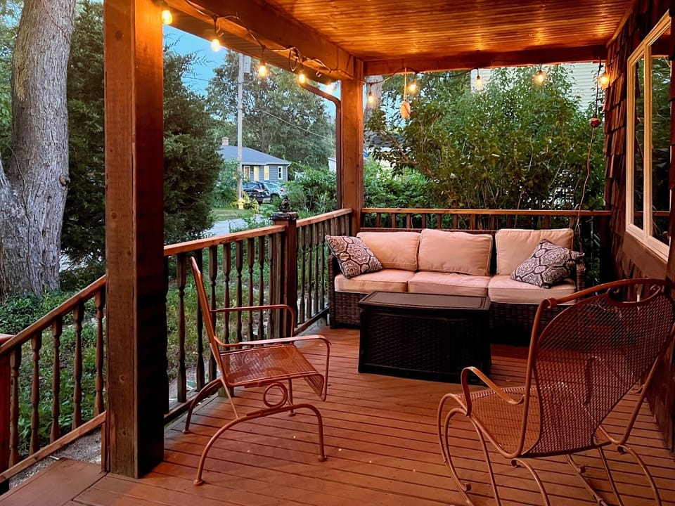 Enjoy fresh lake breeze and serenity of nature from expansive covered porch