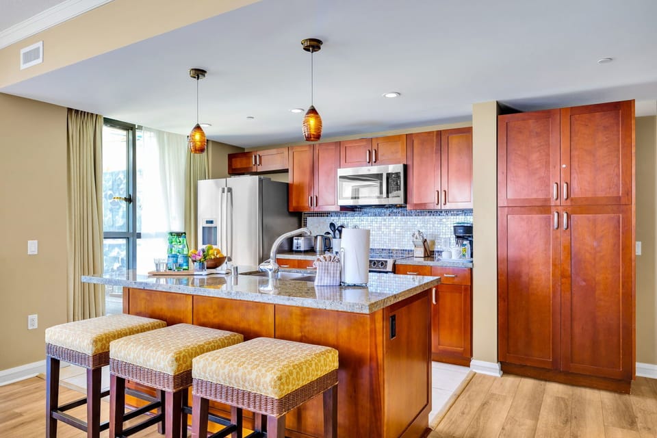 The kitchen island features seating for three and is the perfect spot to sip coffee 