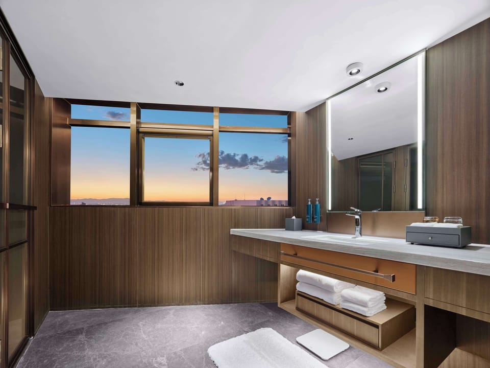 Deluxe Suite, 1 King Bed | Bathroom | Shower, rainfall showerhead, hair dryer, bathrobes