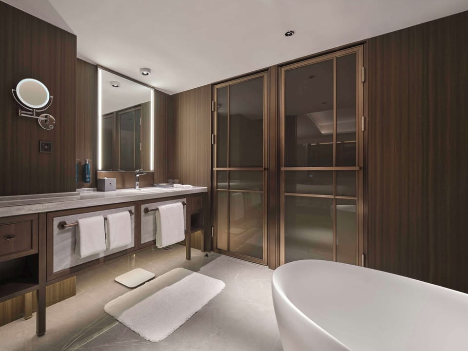 Premium Suite, 1 King Bed | Bathroom | Shower, rainfall showerhead, hair dryer, bathrobes