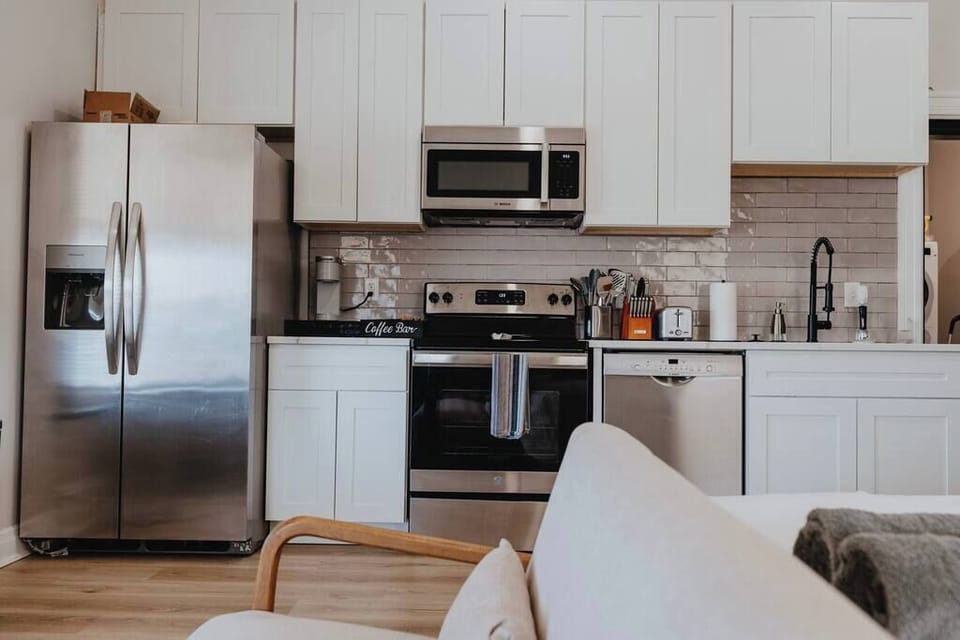 Full kitchen — stainless fridge, stove, and microwave