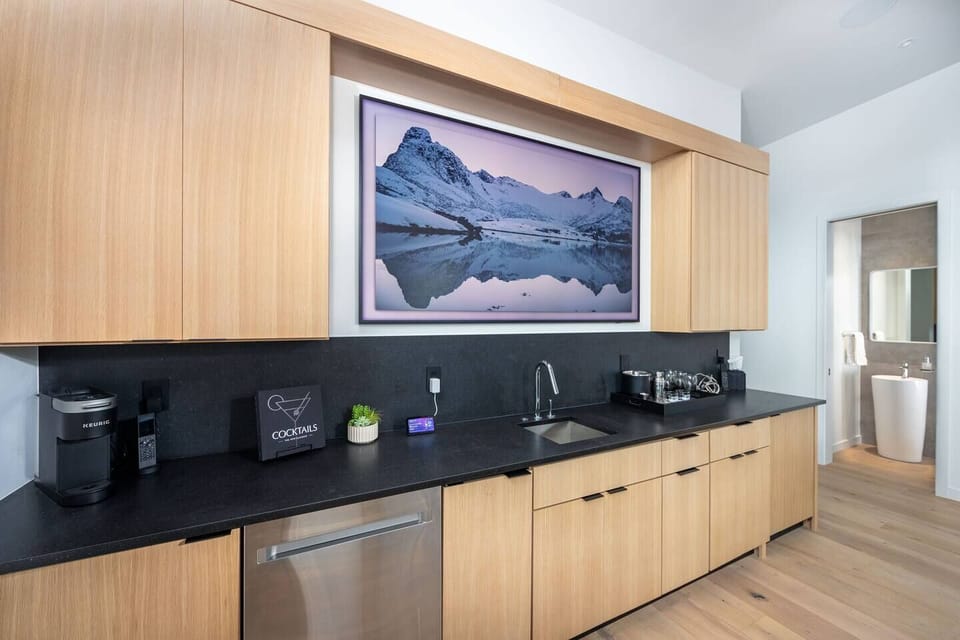 The wet bar in the loft is fully stocked with glasses, Keurig coffee maker, dishwasher, ice machine and massive flatscreen TV.