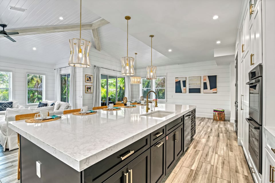 Gather around the island—sunlight pouring in, dishes set, and plenty of space for creating meals together.