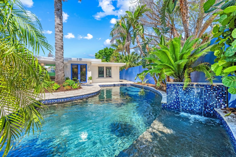 A gentle waterfall cascades into the pool beside the Baja shelf—perfect for lounging in sun-kissed shallows.