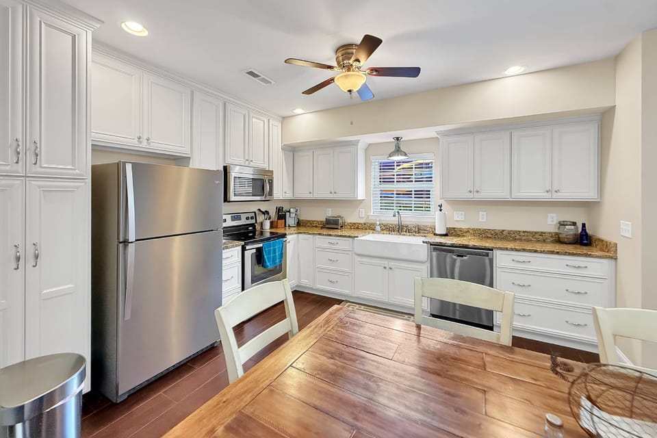 Fully stocked kitchen has ample dishes, glasses, silverware, bowls, pots and pans for quick food on the run or full meals.