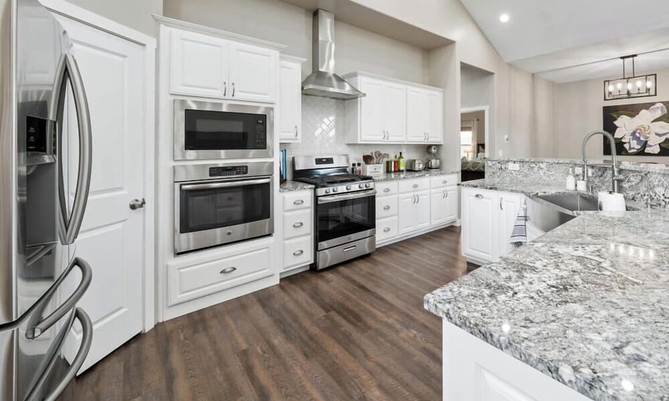 "Experience luxury living in this modern Irvie Home featuring a fully-equipped chef's kitchen with gleaming granite countertops, top-of-the-line stainless steel appliances, and an inviting open-plan design perfect for entertaining. Book your upscale getaway now!"