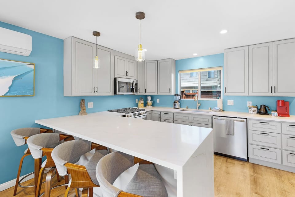 Enjoy mingling with the cook having massive counter top space in this very large modern kitchen. 