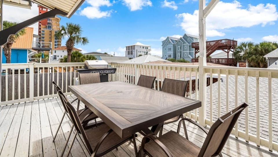 Enjoy meals with ocean breeze on your private deck, featuring spacious dining for eight with coastal views.