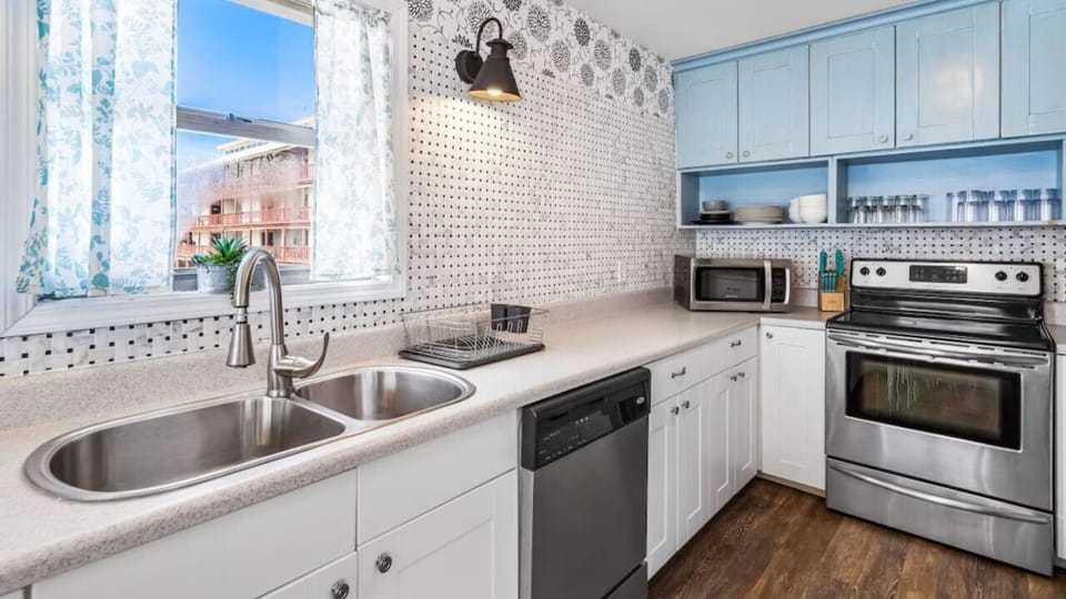 Your fully equipped kitchen features modern appliances and bright windows, perfect for preparing meals during your stay.