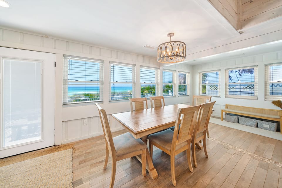 Savor meals in this sun-filled dining room where panoramic ocean views stretch beyond every window, creating the perfect backdrop for your gatherings.