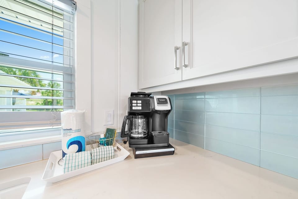 Start your mornings perfectly with this sleek coffee station, complete with premium brewing equipment and natural light streaming in.