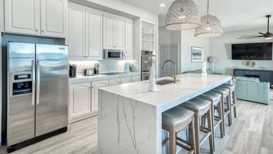 Your fully equipped kitchen sparkles with marble countertops and stainless appliances, perfect for cooking memorable meals together.