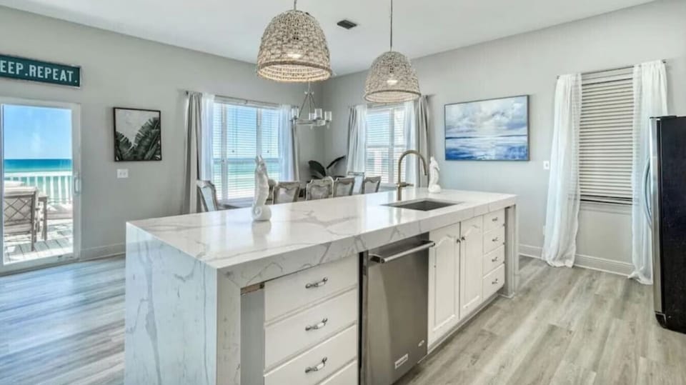 Your fully equipped kitchen with stunning ocean views makes vacation cooking a joy. Beautiful marble counters and beach glimpses create the perfect cooking backdrop.