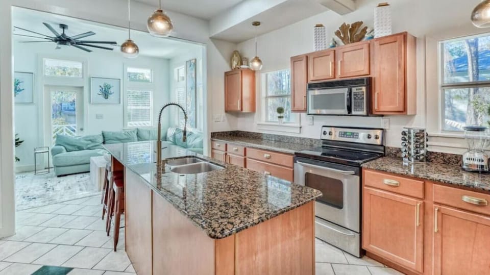 Your spacious open kitchen features granite countertops, stainless steel appliances, and flows seamlessly into the bright living area.