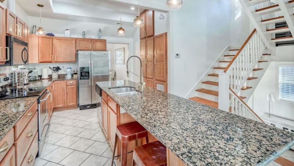 Your spacious gourmet kitchen features granite countertops, premium appliances, and a large island perfect for cooking memorable meals during your stay.