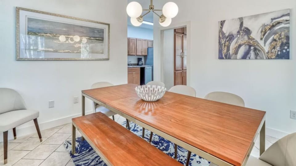 Gather around your beautifully appointed dining table, where warm wood tones and elegant lighting create the perfect setting for memorable meals together.