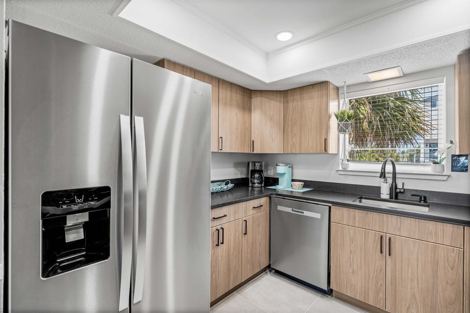 Cook with ease in your sleek, fully-equipped kitchen featuring stainless steel appliances and warm wood cabinetry.