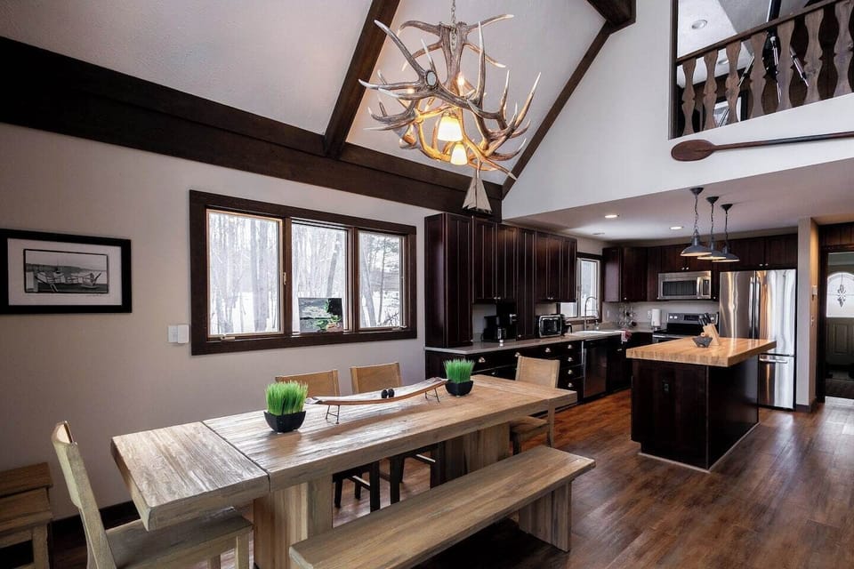 Gather around the spacious dining table and enjoy meals prepared in the fully equipped kitchen—ideal for large groups!