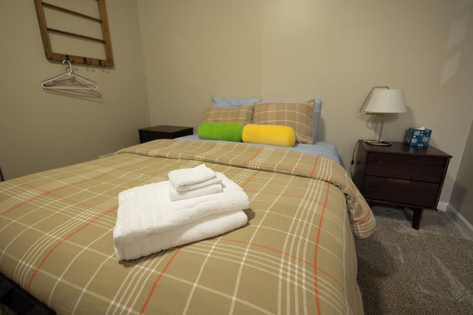 Spacious bedroom with natural light, dual beds, and easy access to the outdoor patio for fresh air and relaxation