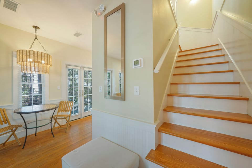 STAIRS TO PRIMARY BEDROOM UP, AND TWO MORE PORCHES