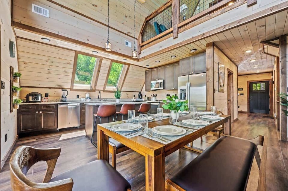 Spacious kitchen and dining room with natural light and forest views.