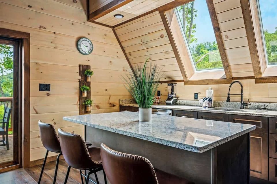 Skylit kitchen with granite countertops and everything you need to cook in.