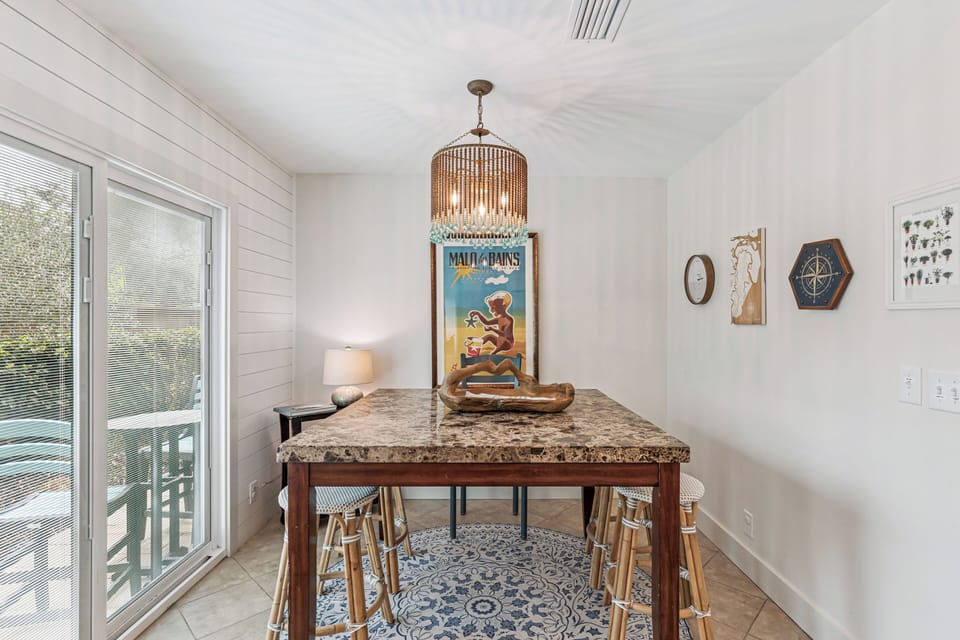 Gather around this granite island for morning coffee or evening cocktails under warm chandelier light.