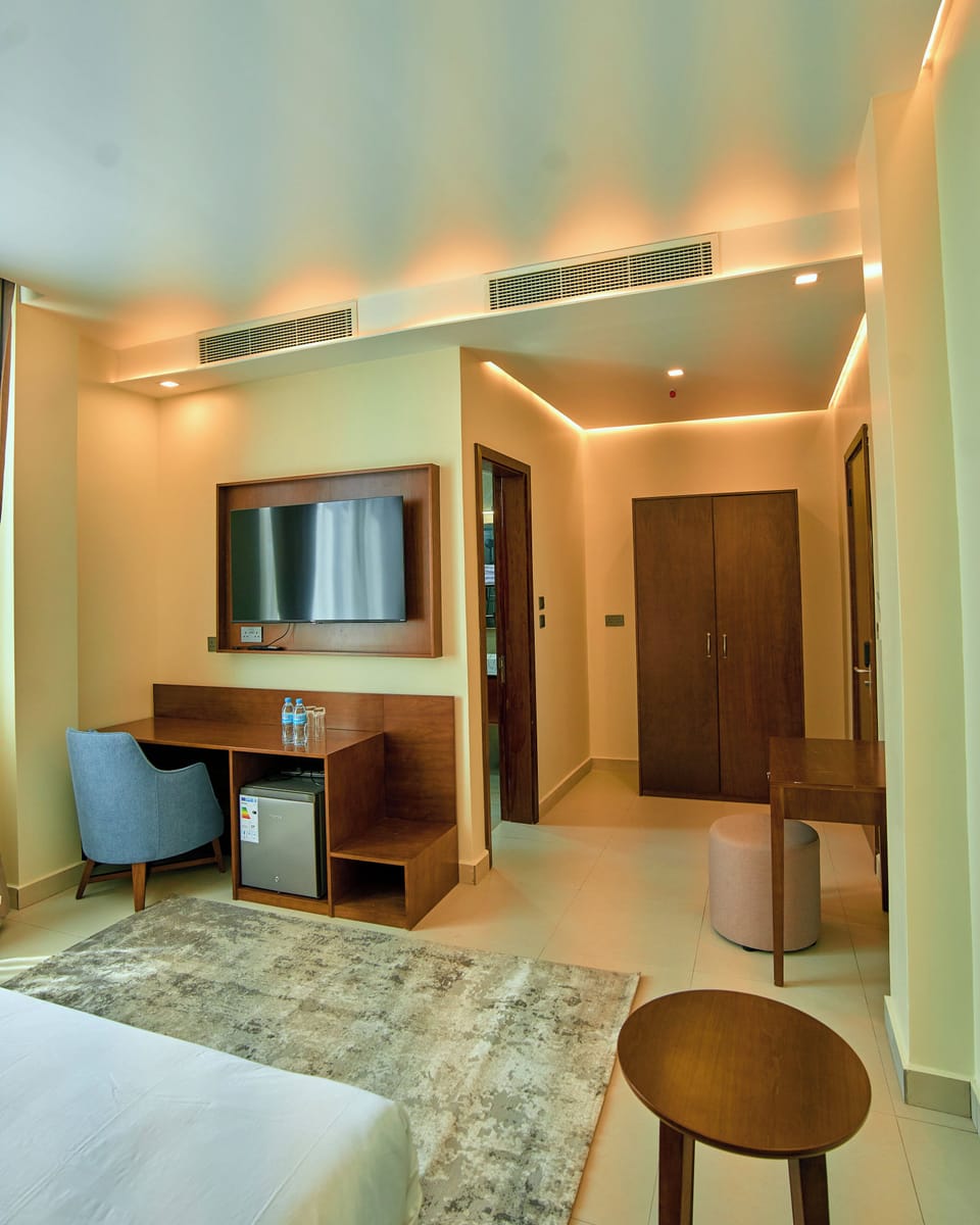 Deluxe Suite, City View | In-room safe, desk, laptop workspace, iron/ironing board