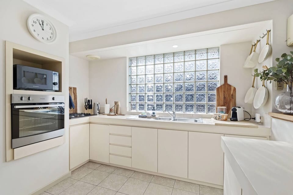 This bright and well-appointed kitchen makes cooking a breeze! Enjoy the convenience of a microwave, oven, and gas stovetop, alongside generous counter space. 