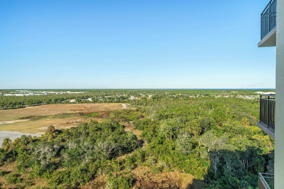 View of expansive green landscape and clear sky from the balcony