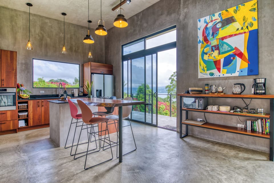 The kitchen area with breakfast bar, coffee/tea/beverage bar with a view.