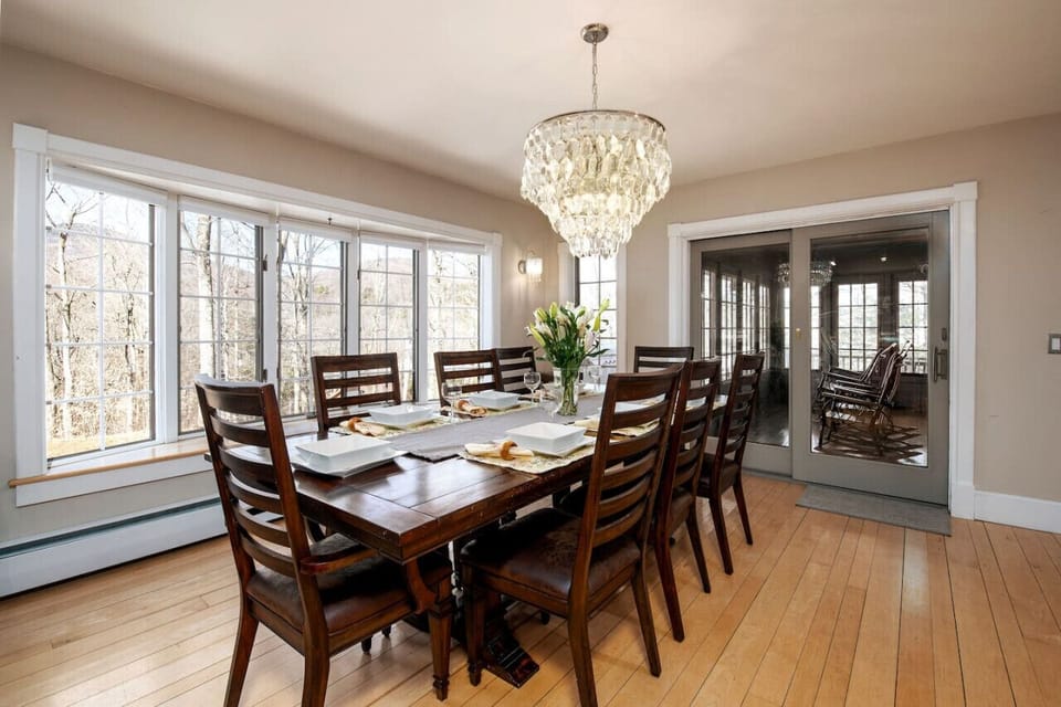 Dining table facing large window with mountain views.