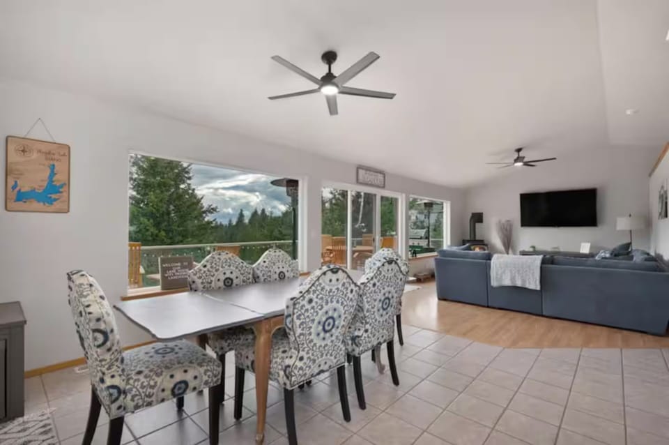 Dining table with seating for 6 and 4 barstools at kitchen counter.