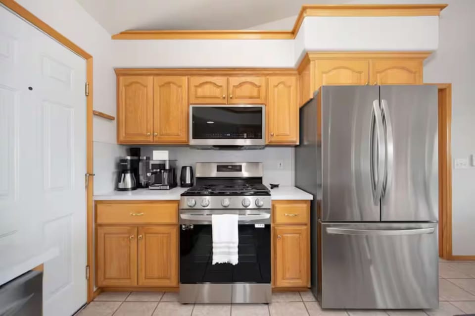 Fully stocked kitchen with modern appliances, spacious counters.