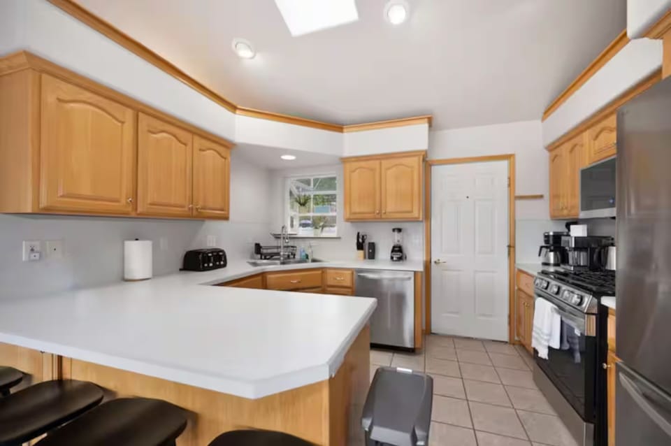 Fully stocked kitchen with modern appliances, spacious counters.