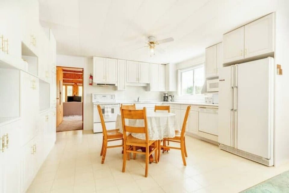 main floor kitchen in full view.  kitchen window overlooks lake (south)