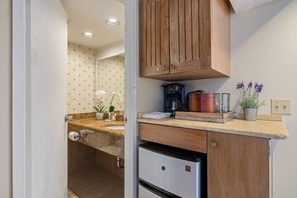Handy coffee bar w/ maker & mini fridge for quick mornings.