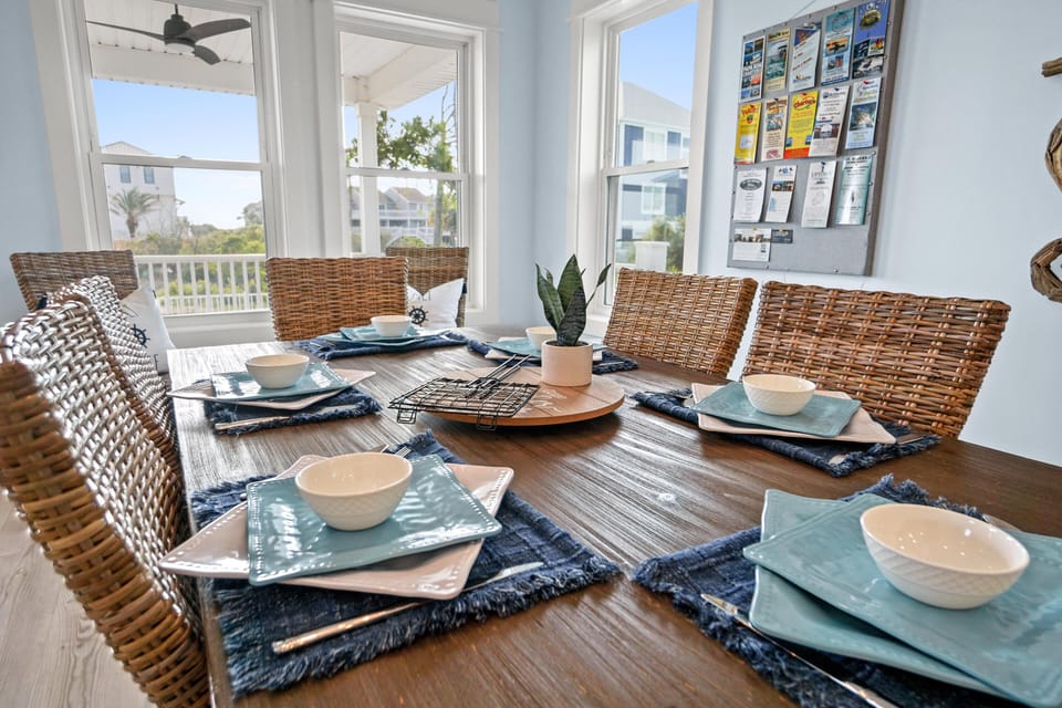 Gather around your beautifully set dining table, where ocean-view windows frame memorable meals with loved ones in coastal comfort.