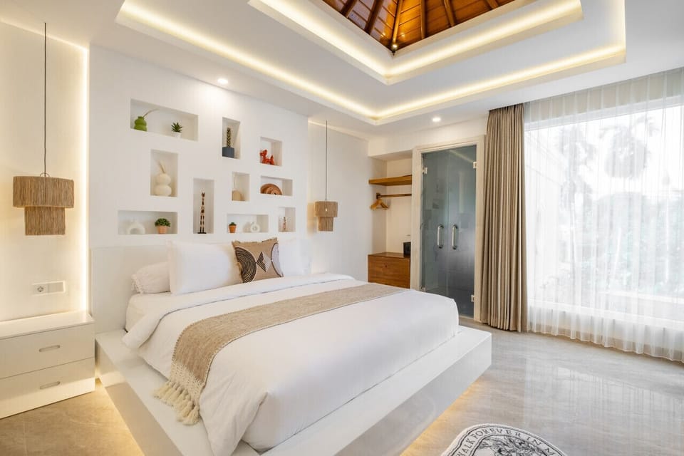 Bedroom designed with a king-size bed, smart TV, and attached bathroom.