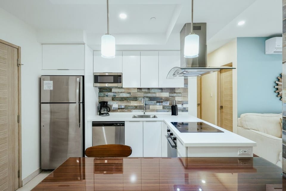Fully equipped kitchen featuring modern appliances, cookware, essentials, and ample space for meal preparation.