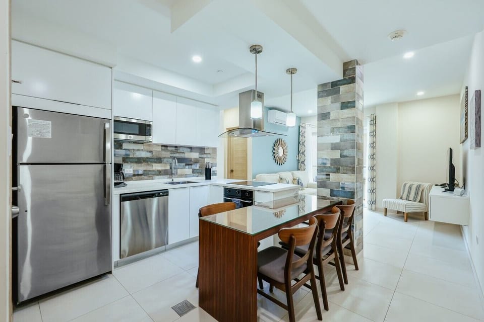 Fully equipped kitchen featuring modern appliances, cookware, essentials, and ample space for meal preparation.