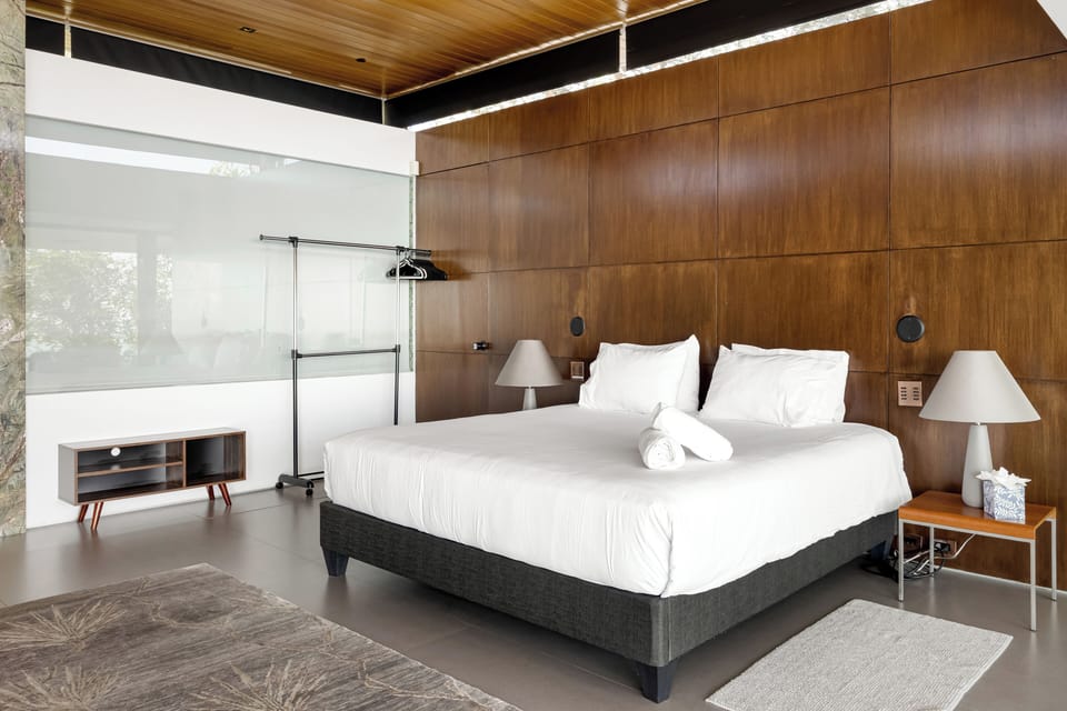 Primary bedroom features a king bed, fireplace, balcony, and ensuite bathroom.