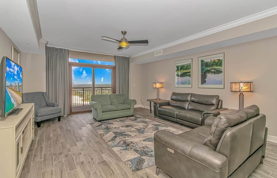 Spacious living room with comfortable seating and large flat-screen TV