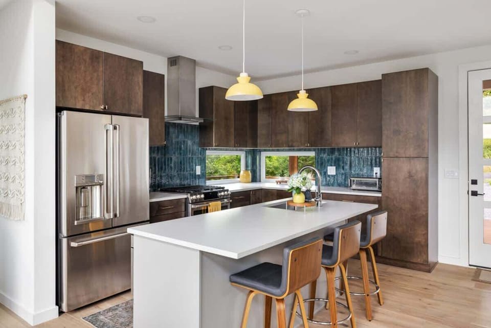 The kitchen island features seating for three. Perfect for casual meals, morning coffee, or keeping the chef company while dinner’s on.