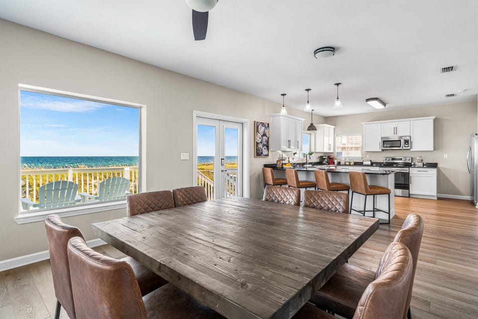 Gather around your stunning dining table while ocean views stretch endlessly before you through floor-to-ceiling windows.