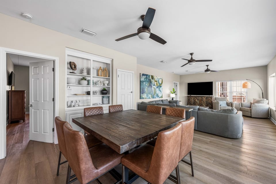 Gather around this stylish dining table while staying connected to your group in the spacious living area beyond.